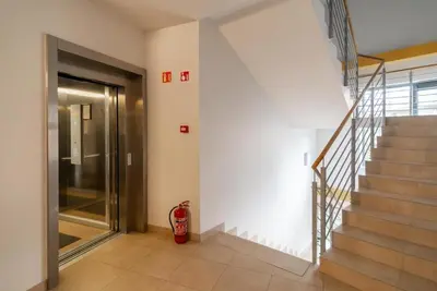a hallway with stairs and a fire hydrant next to a door at 2 Bedroom Apt with Balconies in Druskininkai