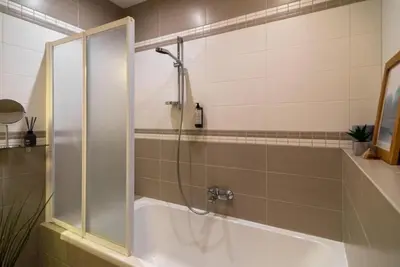 a bathroom with a shower and a bath tub at 2 Bedroom Apt with Balconies in Druskininkai