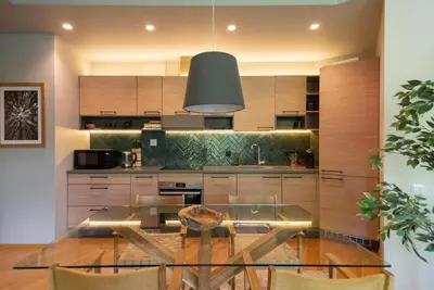 a kitchen with a glass table in a kitchen at 2 Bedroom Apt with Balconies in Druskininkai