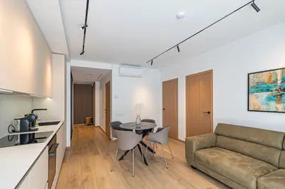 a living room with a couch and a table at Modern 2 BD Apartment by Domvia in Kaunas