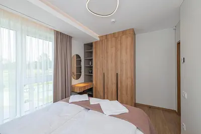 a bedroom with a bed and a large window at Modern 2 BD Apartment by Domvia in Kaunas