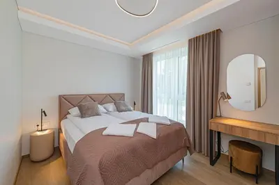 a bedroom with a large bed with a large window at Modern 2 BD Apartment by Domvia in Kaunas
