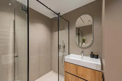 a bathroom with a shower and a sink and a mirror at Modern 2 BD Apartment by Domvia in Kaunas