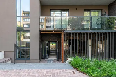a building with a balcony and a glass door at Modern 2 BD Apartment by Domvia in Kaunas
