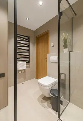 a bathroom with a toilet and a glass shower at Modern 2 BD Apartment by Domvia in Kaunas