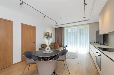 a kitchen and living room with a table and chairs at Modern 2 BD Apartment by Domvia in Kaunas