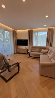 a living room with a couch and a tv at L18 Apartamentai in Kaunas
