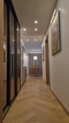 a corridor of a hallway with a dining room at L18 Apartamentai in Kaunas