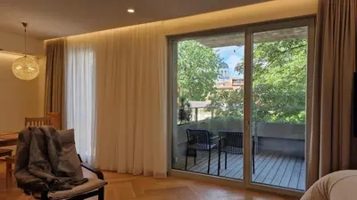 a living room with a sliding glass door to a balcony at L18 Apartamentai in Kaunas