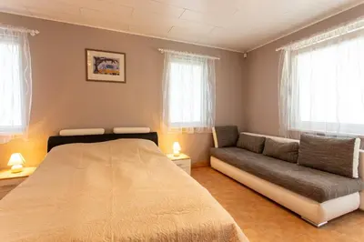 a bedroom with a bed and a couch at Rinvasta in Druskininkai