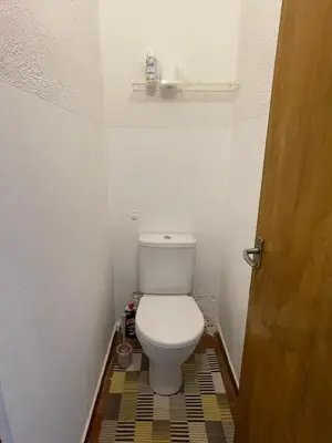 a bathroom with a toilet in a small room at Žaliakalnio panoramos apartamentai in Kaunas