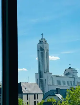a view of a city skyline with a tall building at Žaliakalnio panoramos apartamentai in Kaunas