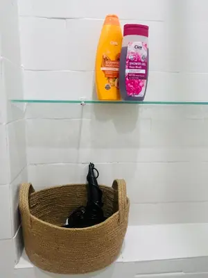 a shelf with a basket and condiments in a refrigerator at Žaliakalnio panoramos apartamentai in Kaunas