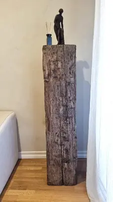 a statue of a man sitting on top of a wooden stump at Artsy Retreat In The Heart Of Uzupis, Vilnius in Vilnius