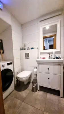 a white bathroom with a toilet and a sink at Artsy Retreat In The Heart Of Uzupis, Vilnius in Vilnius