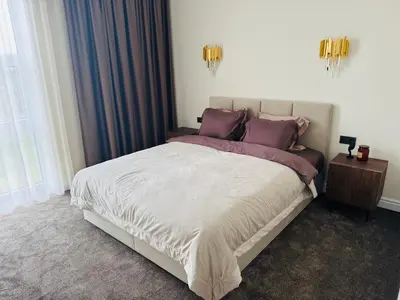 a bedroom with a large bed with purple pillows at Studija 17 butai in Kaunas