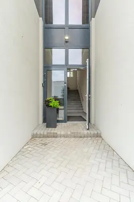 a hallway of a building with a potted plant at Studija 17 butai in Kaunas
