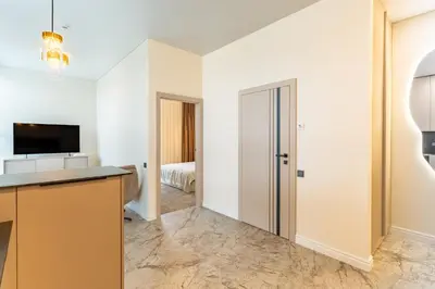 an apartment with a kitchen and a bedroom at Studija 17 butai in Kaunas