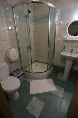 a bathroom with a shower and a toilet and a sink at Poilsiavietė - kempingas ''Viktorija''