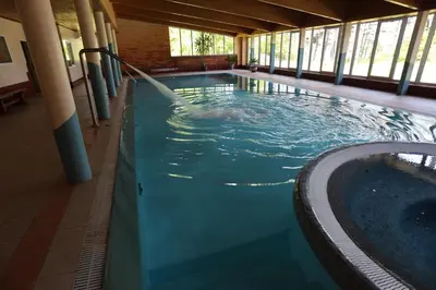 a person in a pool with a water fountain at Poilsiavietė - kempingas ''Viktorija''