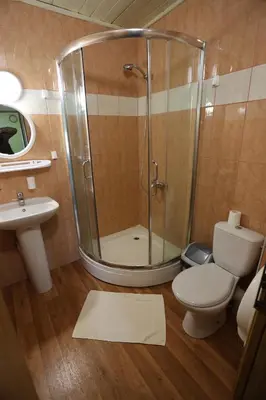 a bathroom with a shower and a toilet and a sink at Poilsiavietė - kempingas ''Viktorija''
