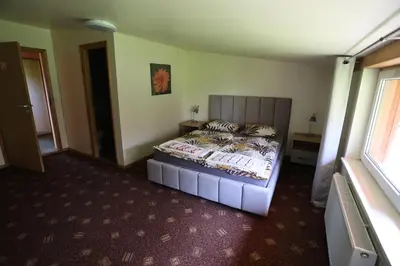 a bedroom with a bed in a room at Poilsiavietė - kempingas ''Viktorija''
