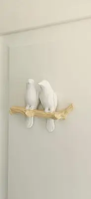 a shelf with three white vases on it at Vila Skodupė