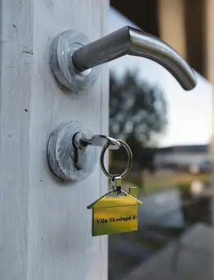 a lock on a door with a sign on it at Vila Skodupė