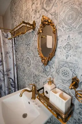 a bathroom with a sink and a mirror at Vila Skodupė