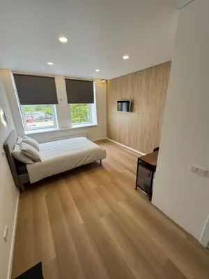 a bedroom with a bed and a window and a desk at 9 New Airport Apartment in VNO