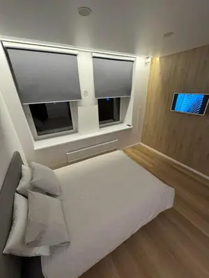 a bedroom with a bed and two windows at 9 New Airport Apartment in VNO