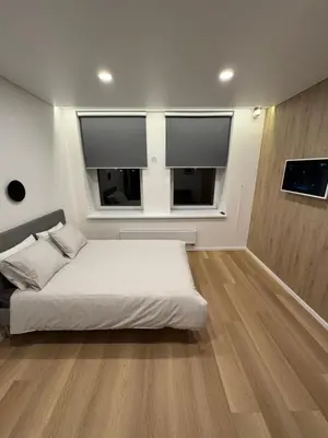 a bedroom with a white bed and two windows at 10 New Airport Apartment in VNO