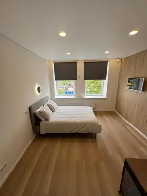 a large bedroom with a bed and a window at 10 New Airport Apartment in VNO