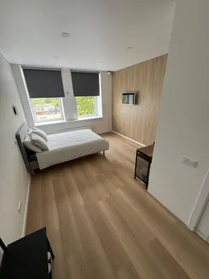 a bedroom with a bed and two windows at 10 New Airport Apartment in VNO