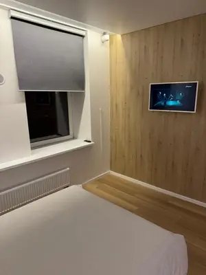 a bedroom with a flat screen tv and a bed at 10 New Airport Apartment in VNO