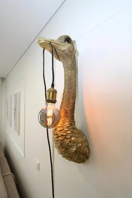 a bird head lamp hanging on a wall at Flat for 2 or 1 with Free Parking and Fast Wi-Fi in Vilnius