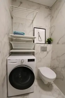 a bathroom with a washing machine and a toilet at Flat for 2 or 1 with Free Parking and Fast Wi-Fi in Vilnius