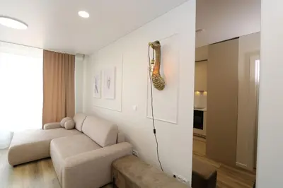 a living room with a couch and a table at Flat for 2 or 1 with Free Parking and Fast Wi-Fi in Vilnius