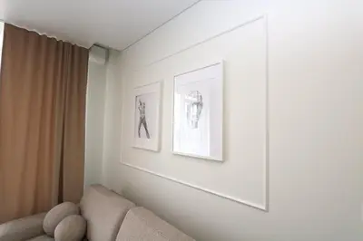 a living room with a couch and two pictures on the wall at Flat for 2 or 1 with Free Parking and Fast Wi-Fi in Vilnius