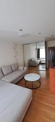 a living room with a couch and a table at Apartamentai The 56 Spot in Utena
