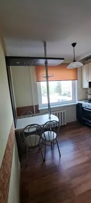 a kitchen with a table and chairs in a room at Apartamentai The 56 Spot in Utena