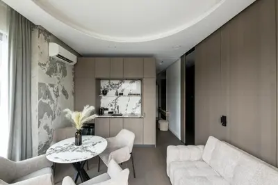 a living room with a table and white chairs at CityView Kaunas Center in Kaunas