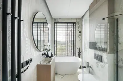 a bathroom with a tub and a sink and a mirror at CityView Kaunas Center in Kaunas