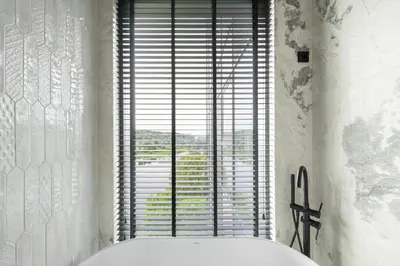 a bathroom with a tub and a large window at CityView Kaunas Center in Kaunas