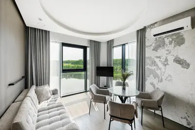 a living room with a couch and a table and chairs at CityView Kaunas Center in Kaunas
