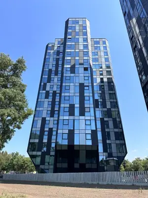 a tall glass building with a blue sky in the background at CityView Kaunas Center in Kaunas