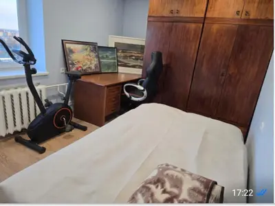 a bedroom with a bed and a desk and a desk at Apartaments Kaunas in Kaunas
