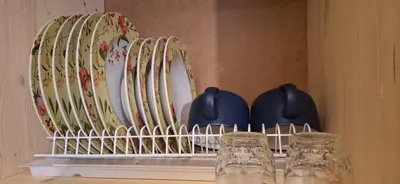 a rack with utensils sitting on a shelf at Boho House in Šiauliai