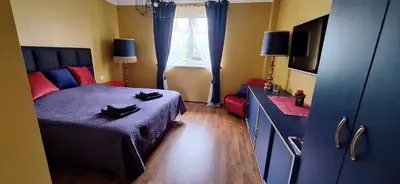 a bedroom with a bed and a dresser and a window at Boho House in Šiauliai