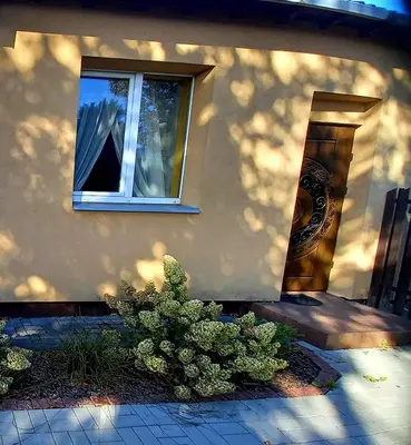 a building with a window on the side of it at Boho House in Šiauliai